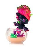 The tokidoki (IT) Neon Reef Mermicorno Blind Box features a vibrant unicorn figure with neon pink, green, and purple highlights in a clear bowl with sand and green accents—ideal for any collectible display.