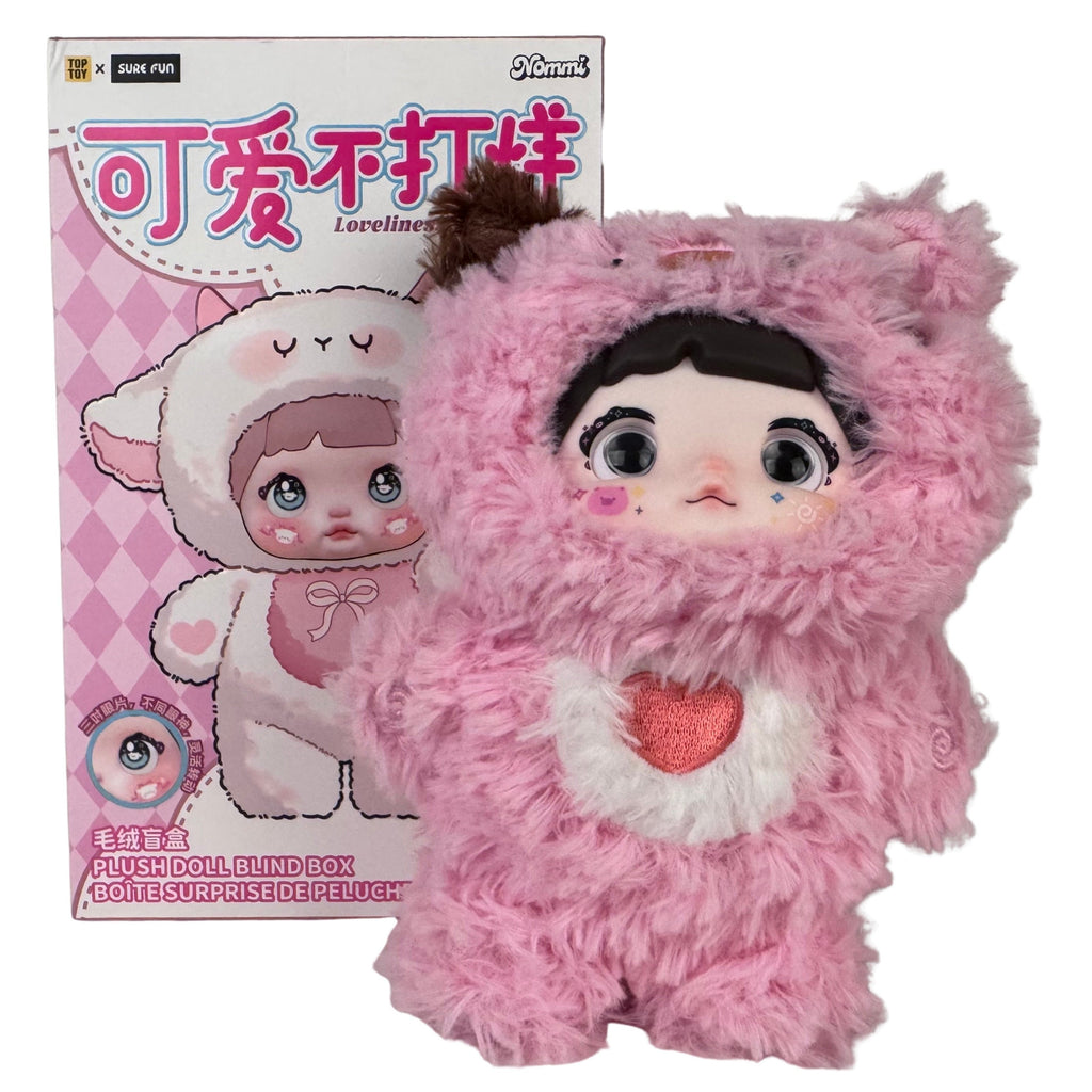 A Nommi Loveliness Never Ends Plush blind box figure with a smooth face wearing a fluffy pink bear suit with a red heart on the chest, displayed in front of its illustrated product box.
