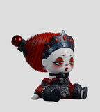 The A Mad Tea Party Blind Box by Kaleidos Creative features a toy figure with a large red hat, jeweled crown, and detailed black and red outfit, sitting neutrally on a light gray background.