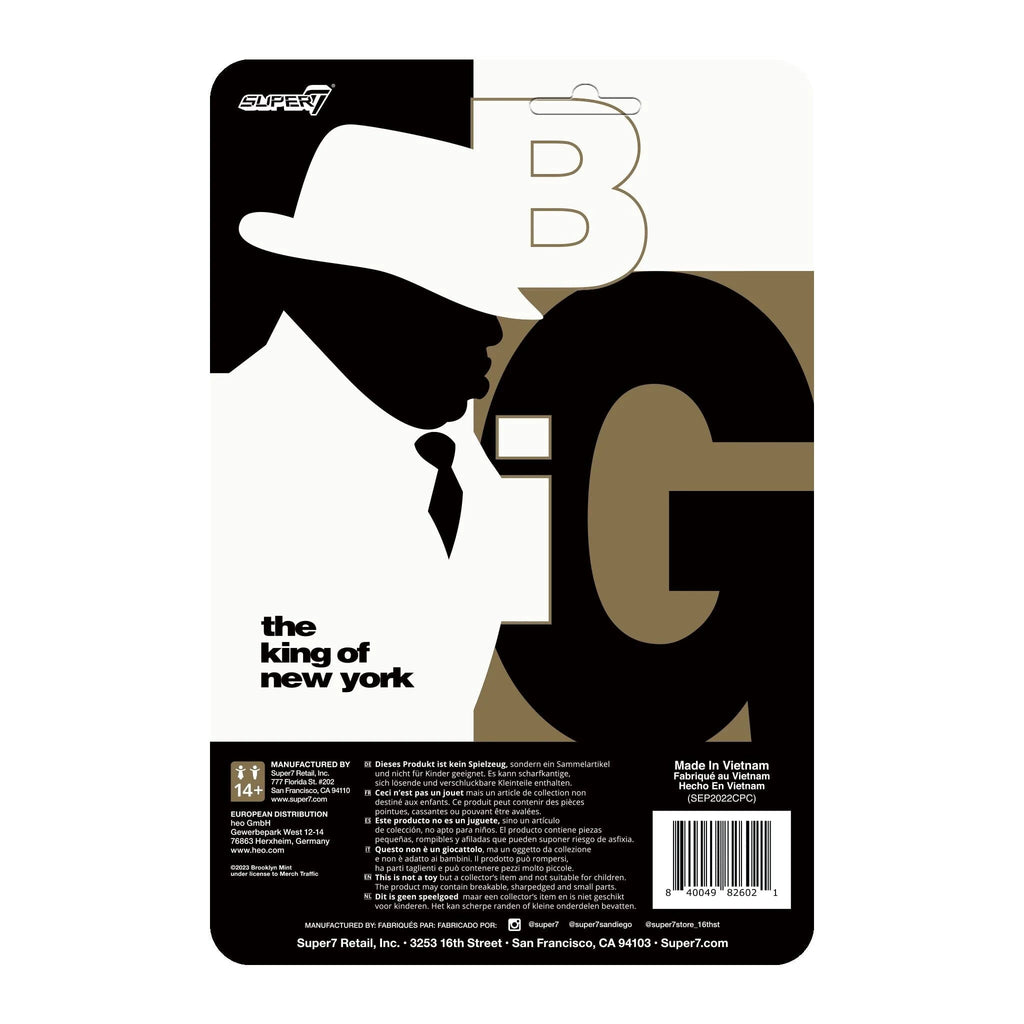 A black and white image of a man wearing a hat, resembling the hip-hop legend, Notorious B.I.G. - Super 7 (US) Notorius B.I.G. ReAction - Biggie In Suit