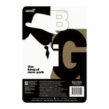 A black and white image of a man wearing a hat, resembling the hip-hop legend, Notorious B.I.G. - Super 7 (US) Notorius B.I.G. ReAction - Biggie In Suit