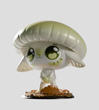 Vinyl figurine from the Capkins Series 1 Blind Box by Kaleidos Creative, featuring a cute, wide-eyed creature with large ears and a mushroom cap hat standing on leafy base, inspired by the magical Fungi Forest. Plain gray background.