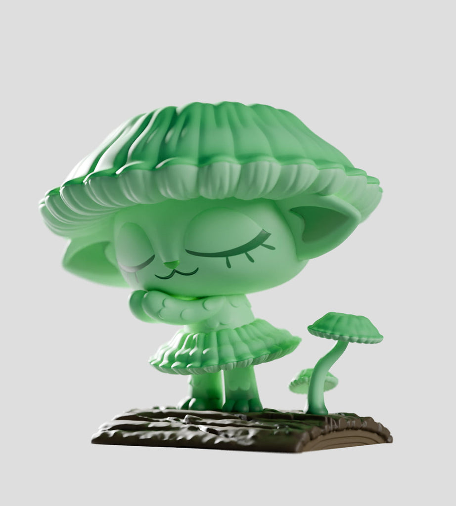 A green, cat-like Capkins figurine from the Capkins Series 1 Blind Box by Kaleidos Creative stands on a textured brown base with a small mushroom, featuring a mushroom cap hat and closed eyes, against a plain gray background.