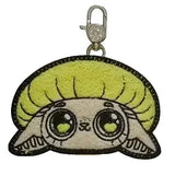 Collectible keychain from Kaleidos Creative, featuring a cute cartoon animal face with big eyes, tan fur, and a lime-green round hairstyle—perfect for Capkins Mystery Coin Bag fans or adding to your blind box collection.