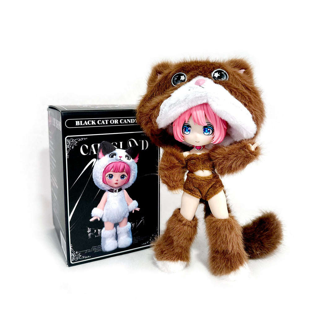 A BIJIDI Cat Island — Black Cat Or Candy Cat? Blind Box doll with pink hair wears a brown cat costume and stands beside its packaging, which shows the doll in a white cat outfit.