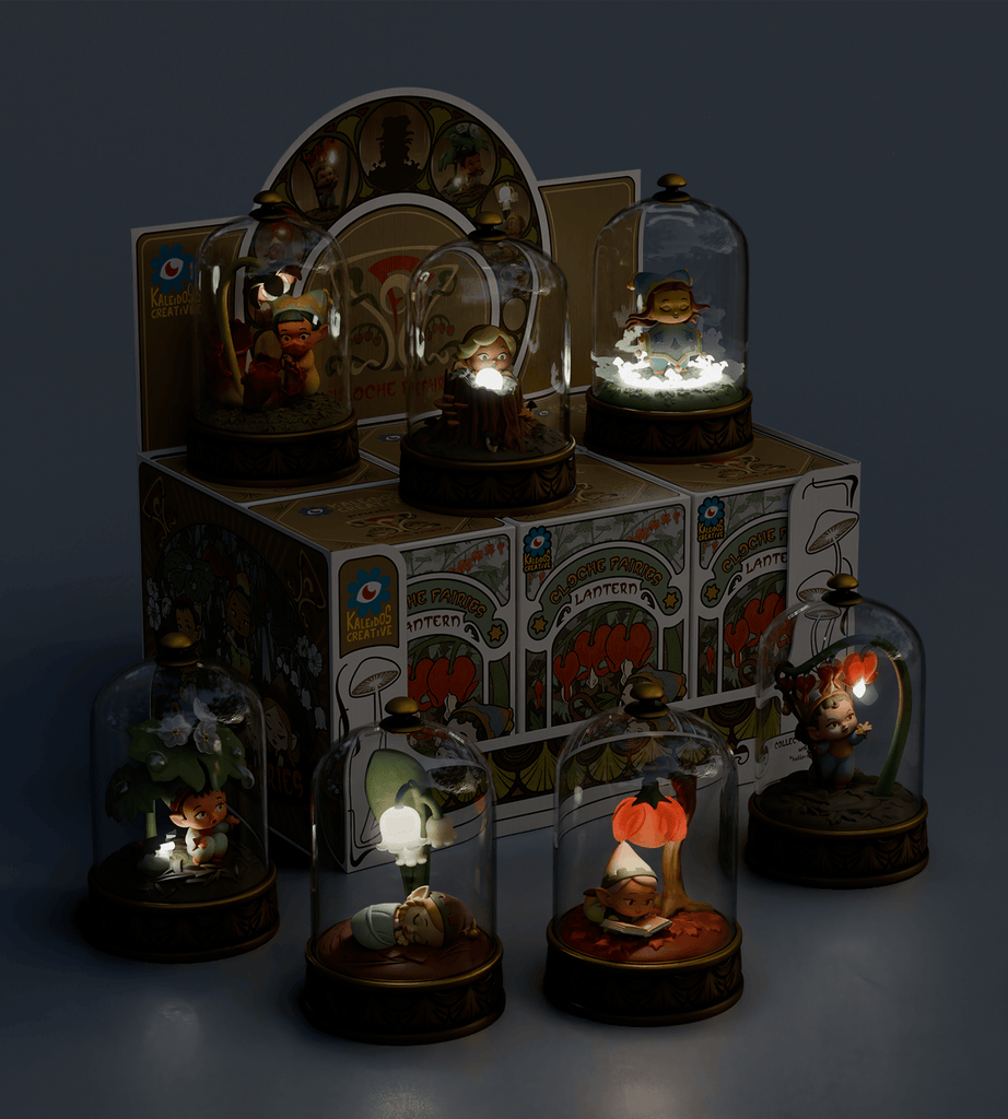 Seven Cloche Fairies from the Kaleidos Creative Cloche Fairies Blind Box are showcased under glass domes on decorated bases, arranged on and around a floral-themed blind box with the brand's logo.