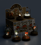 Seven Cloche Fairies from the Kaleidos Creative Cloche Fairies Blind Box are showcased under glass domes on decorated bases, arranged on and around a floral-themed blind box with the brand's logo.