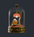 The Cloche Fairies Blind Box by Kaleidos Creative features a charming elf reading under a pumpkin-shaped lamp, encased in a glass dome with a gold base.