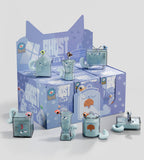 A lineup of blue cat-themed glass containers with tail handles and playful faces sits before a