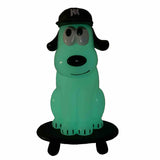 The How 2 Work One-Chu SK8 - Glow figure features a green cartoon dog in a black cap on a black base, perfect for fans of unique glow-in-the-dark collectibles.