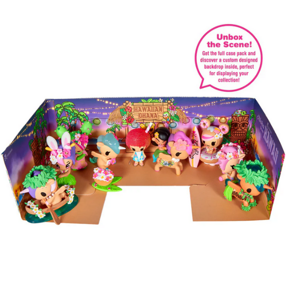 A display of tokidoki Hawaiian Ohana Blind Box collectible dolls is set against a vibrant, tropical-themed cardboard backdrop with a “Hawaiian Ohana” sign.