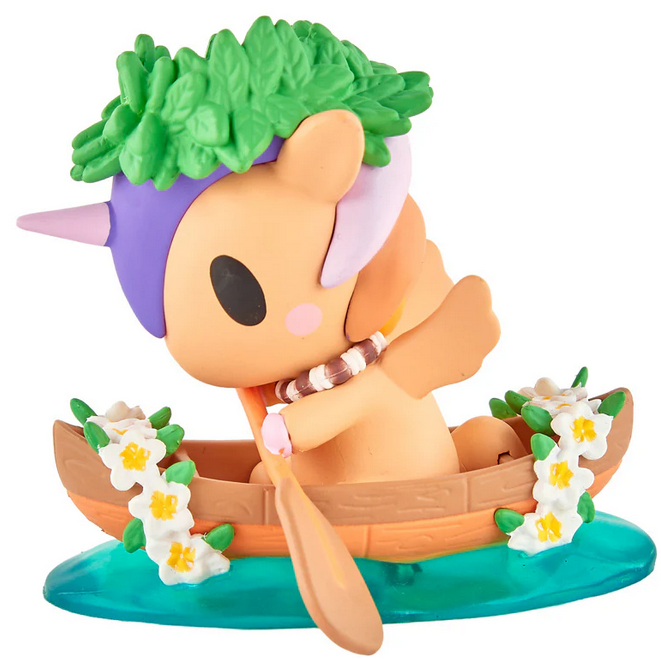 A small tokidoki Hawaiian Ohana Blind Box unicorn figurine, crowned with leaves and paddling a flower-decorated wooden canoe, makes a charming addition to any Unicorno collection.