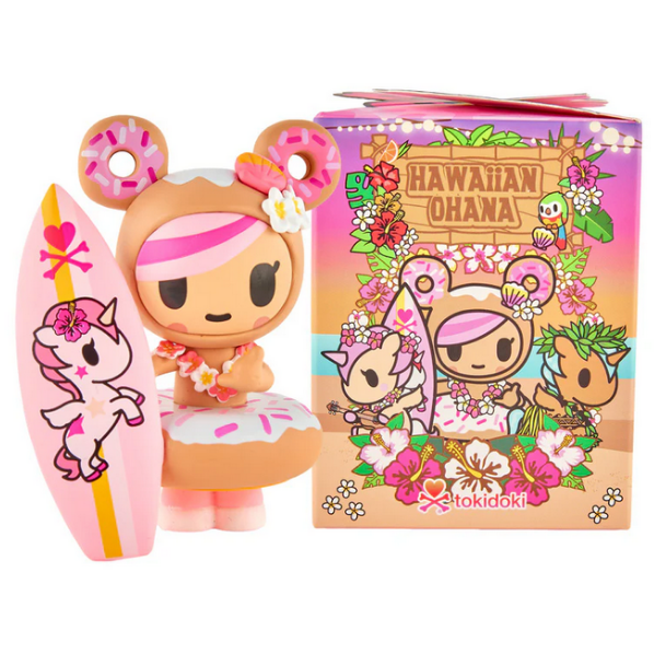 A tokidoki Hawaiian Ohana Blind Box vinyl figurine with donut bear ears, a lei, and a pink surfboard stands by its colorful, cartoon-art box.