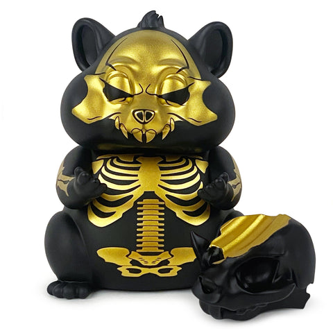 A black skeleton toy sits beside a Hungry Hamster — An Evil Thought skull from the Hungry Hamster Club.