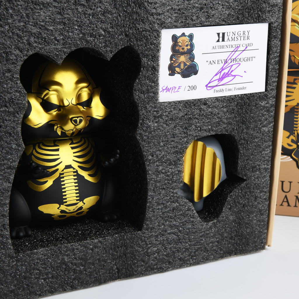 A Hungry Hamster — An Evil Thought skeleton figurine in a box.