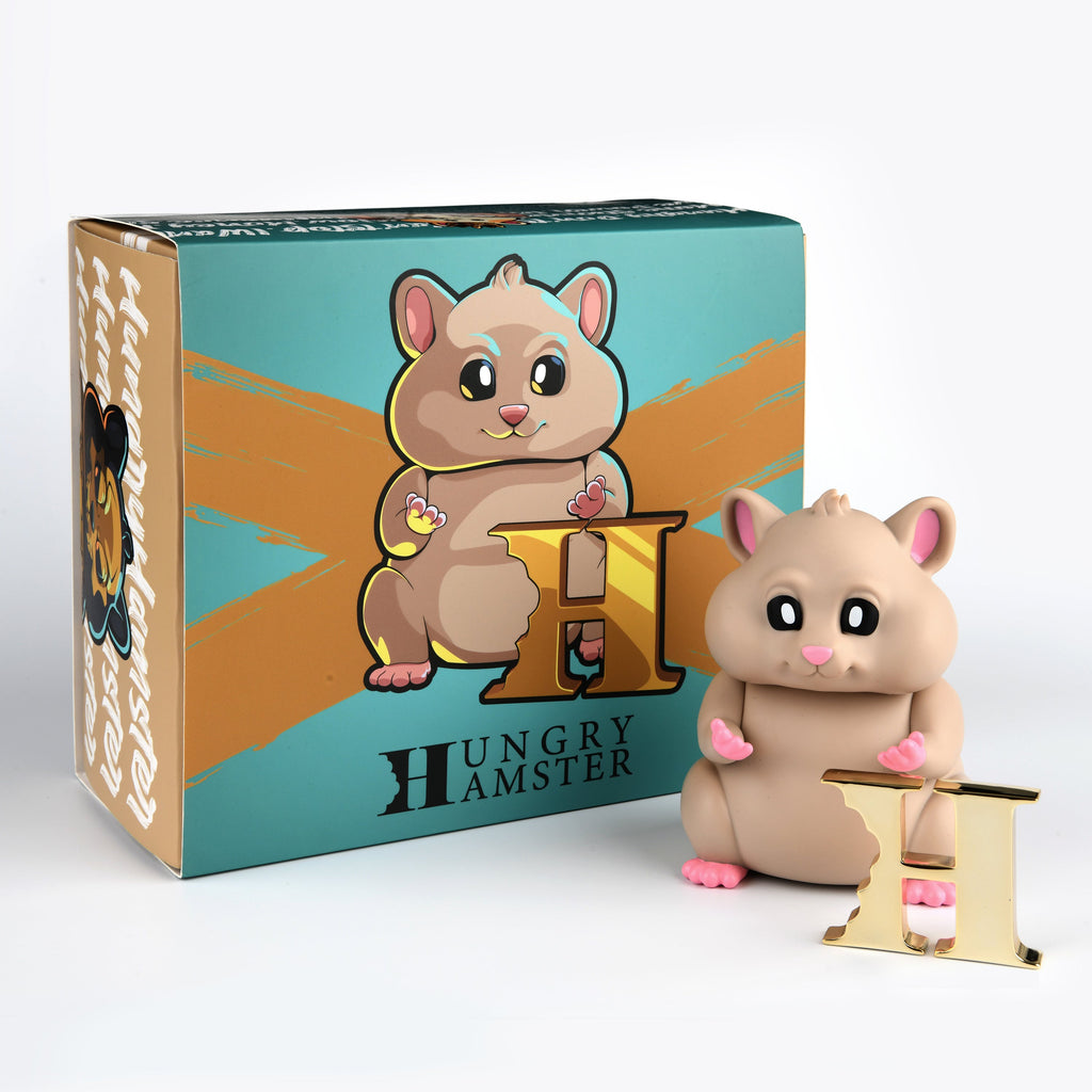 An artist-designed Hungry Hamster — The Original toy in front of a box.