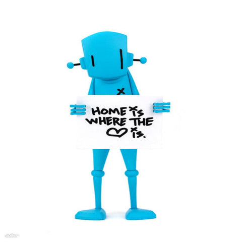 The Chris RWK Blue Robot- "Home is Where The Heart Is" Figure by Rotofugi features a blue robot holding a sign on a plain white background—an ideal choice for unique home decor.