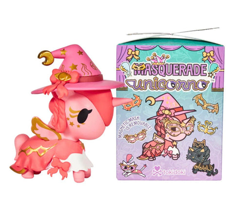 A pink unicorn with a witch hat stands next to the Tokidoki Unicorno After Dark Masquerade Blind Box, adorned with playful illustrations and branding, making it an enchanting collectible toy.