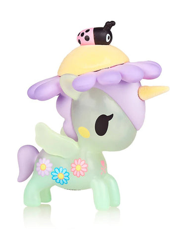 A colorful tokidoki Flower Power Unicorno Series 2 - Daisy (Special Edition) toy unicorn with a yellow hat and a small toy car on top.