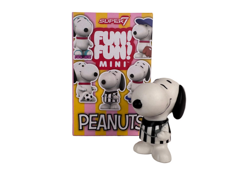 A Peanuts FUN! FUN! Mini - Athlete Snoopy Blind Box referee figurine stands in front of a colorful, branded display of Peanuts collectibles featuring various character designs.