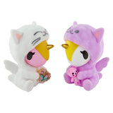 The Tokidoki Twinsies Unicorno Blind Box by tokidoki features two pastel Unicornos in cat costumes—one white with a bouquet, one purple with a pink bear—making them perfect collectibles for any blind box fan.