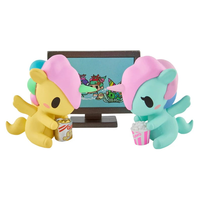 Two Tokidoki Twinsies Unicorno Blind Box collectibles by tokidoki watch TV together, sharing popcorn and snacks.