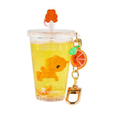 A tokidoki Beverage Besties Unicorno Blind Box collectible keychain features a clear cup with yellow liquid, an orange lion figure, and citrus charms—ideal for fans of beverage-themed surprises.