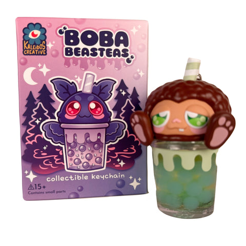 The Boba Beasteas Blind Box by Kaleidos Creative features a bat-like character in a boba tea cup keychain, complete with illustrated packaging and surprise collectible fun from the Cryptid Cuties series.