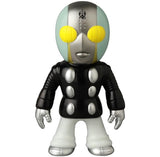 Medicom's VAG 46 — Tane Man is a stylized Vinyl Artist Gacha figure with a round helmet-like head, yellow eyes, black outfit with silver details—perfect for collectors of Japanese vinyl toys and gachapon figures.