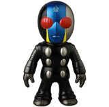 The Medicom VAG 46 — Tane Man is a Japanese vinyl toy figure featuring a black suit, metallic silver details, blue and silver head with red eyes, and yellow face stripes—perfect for fans of collectible Vinyl Artist Gacha gachapon.