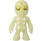 The VAG 46 — Tane Man by Medicom is a glow-in-the-dark Japanese vinyl figure with golden eyes, four white chest dots, and a forehead emblem—ideal for Vinyl Artist Gacha and unique gachapon collectors.