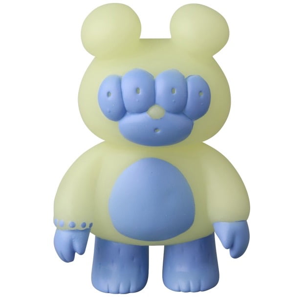 VAG 46 — Matthew by Medicom is a yellow bear-shaped vinyl toy with blue accents on its face, belly, hands, and feet, standing upright—a charming Japanese design inspired by Vinyl Artist Gacha gachapon figures.
