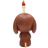 The Keep Balance figurine by How2Work (HK) is a stylized brown dog shown from the back, featuring a lit candle on its head and a small yellow tail.