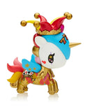 The vibrant Tokidoki Lucky Unicorno from the Blind Box collection, featuring a golden body, jester hat, crown, and rainbow mane, is set against a white backdrop. This enchanting toy is decorated with a heart on its side and the name