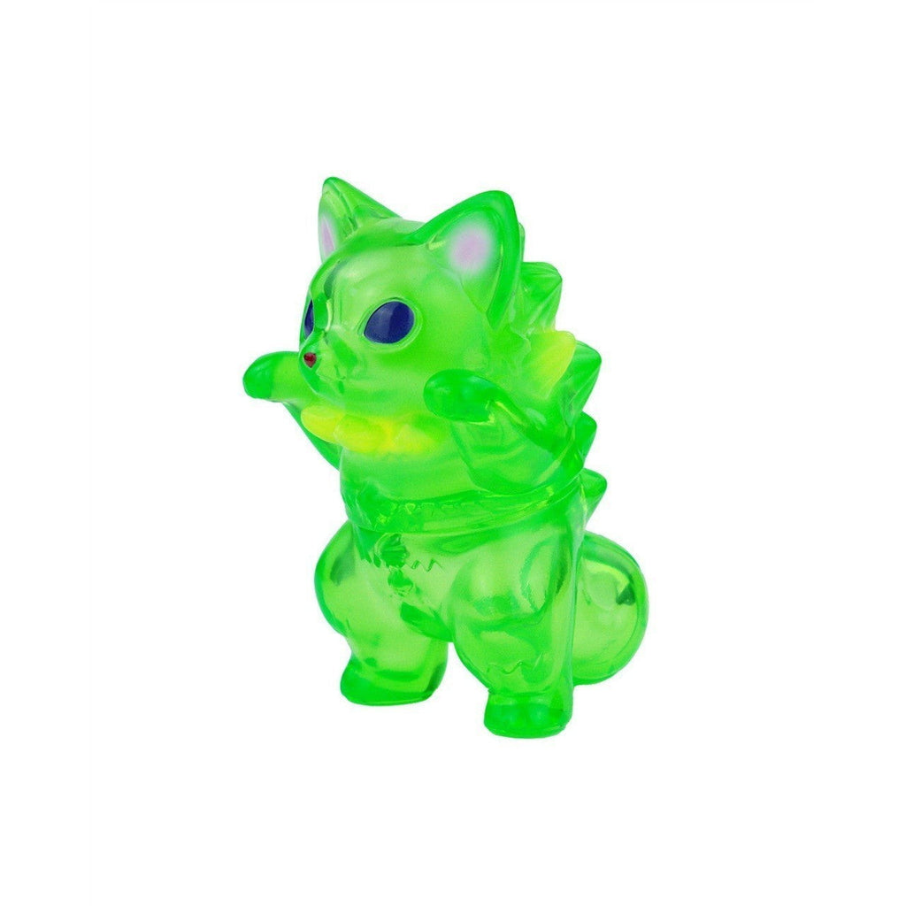 Rotofugi’s Mamera-Tropical is a small, translucent green toy figure resembling an alien cat with a spiky back, standing upright with its front paws raised.