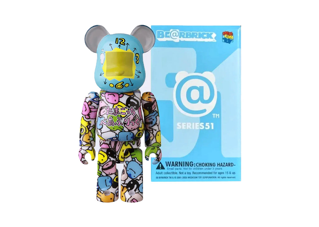 The Medicom Be@rbrick Series 51 Blind Box features a vibrant Bearbrick figure with cartoon faces and a blue box marked with the @ symbol—a must-have collectible for any fan of Bearbricks.