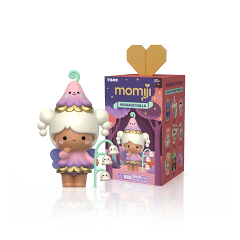 A Momiji — Sugar Plum Woods Blind Box collectible figure with a flower-shaped hat and purple wings standing next to its rectangular product box featuring illustrations of various characters.