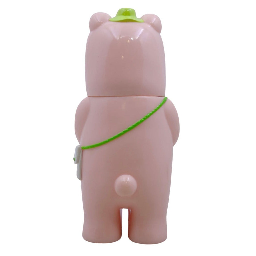 Kurichan - #5 by Paradise Toy is a pink bear-shaped toy with a green hat and shoulder strap, exuding charm. Shown from the back on a white background, it makes an adorable gift.