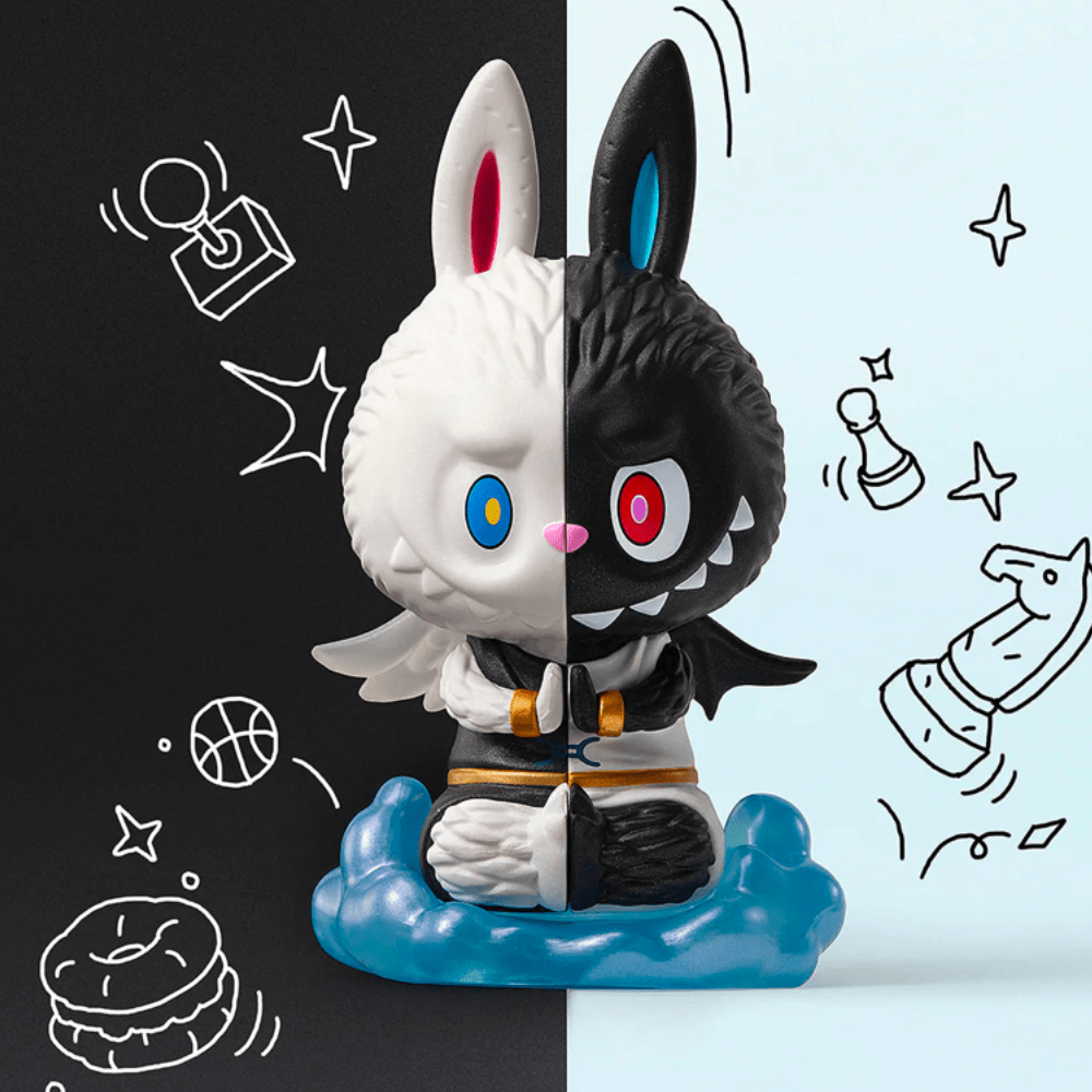 A black and white bunny figurine from the Pop Mart Monsters - Constellation series Blind Box is perched on top of a drawing.