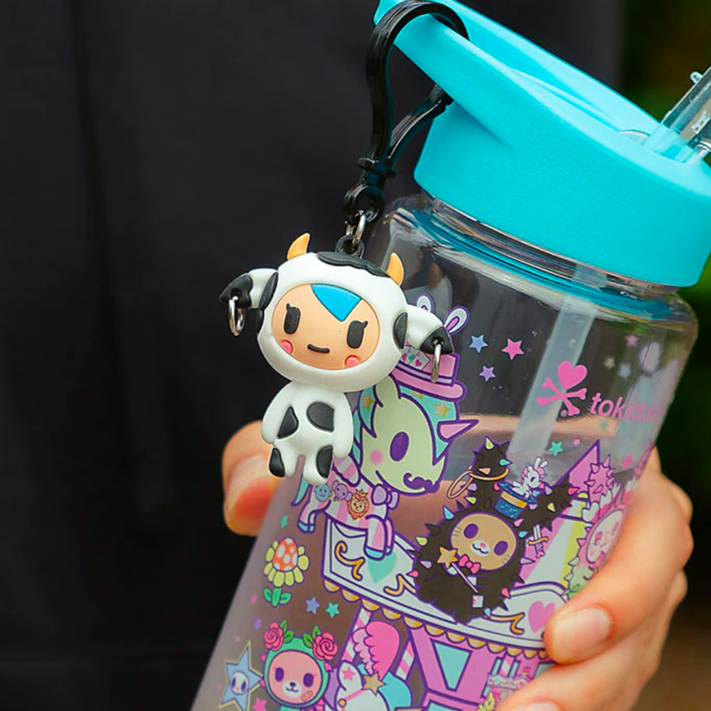 A person holding a collectible water bottle with a tokidoki Characters series 1 Blind Bag Clips on it.
