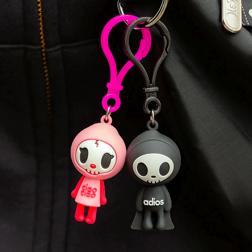Two Tokidoki Characters series 1 Blind Bag Clips hanging from a black jacket.