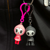 Two Tokidoki Characters series 1 Blind Bag Clips hanging from a black jacket.