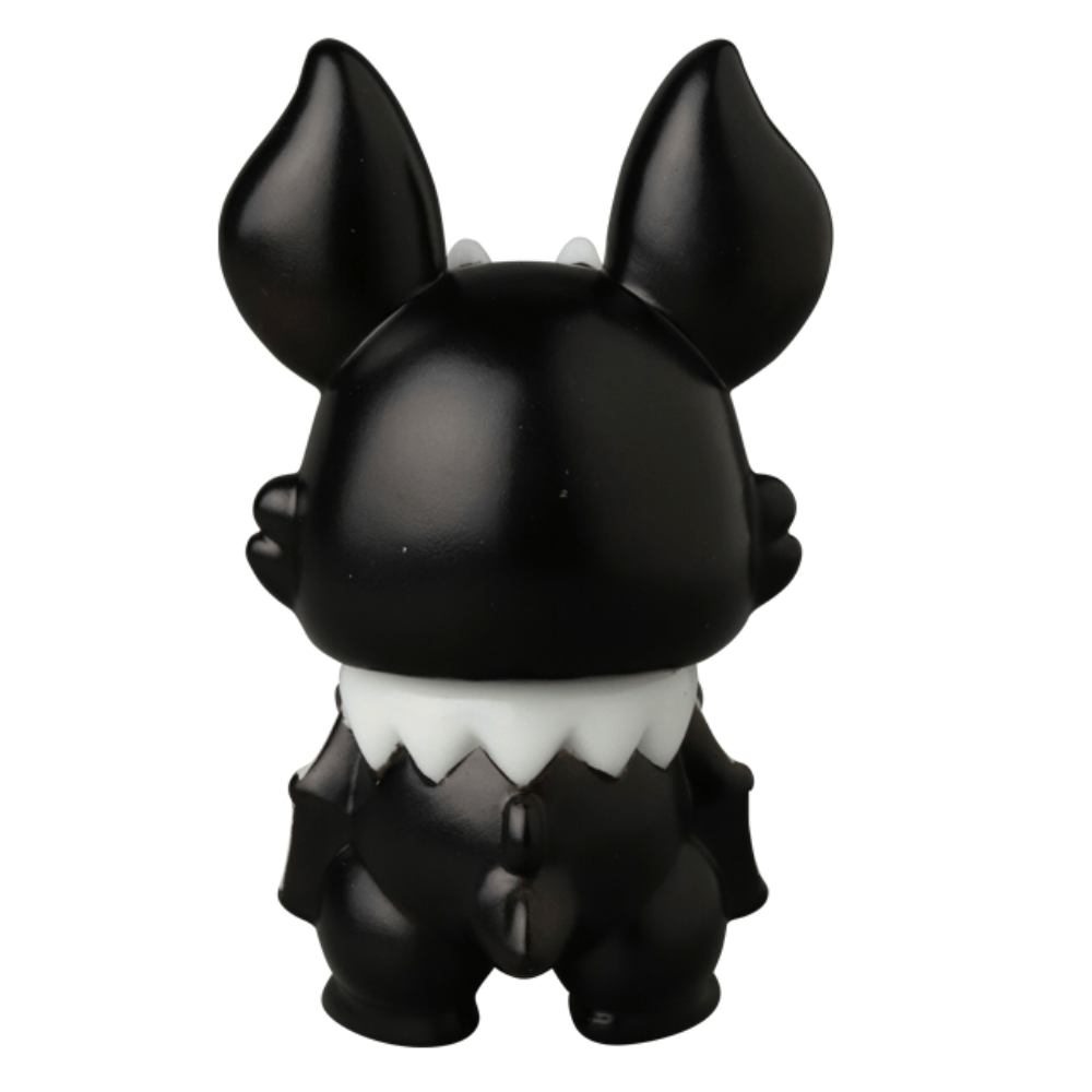 A small black vinyl Kopatapatan figure by Medicom (JP), featuring large upright ears, a white collar detail, and a stubby tail, shown from the back against a white background. Part of the VAG 10th Anniversary series.