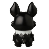 A small black vinyl Kopatapatan figure by Medicom (JP), featuring large upright ears, a white collar detail, and a stubby tail, shown from the back against a white background. Part of the VAG 10th Anniversary series.