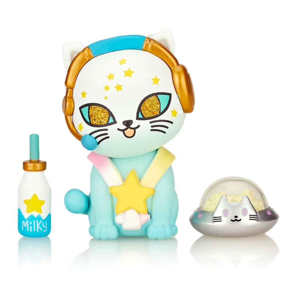 In this adorable scene, a tokidoki Galactic Cats - Blind Box toy cat is sitting next to a shiny star and a bottle of milk.