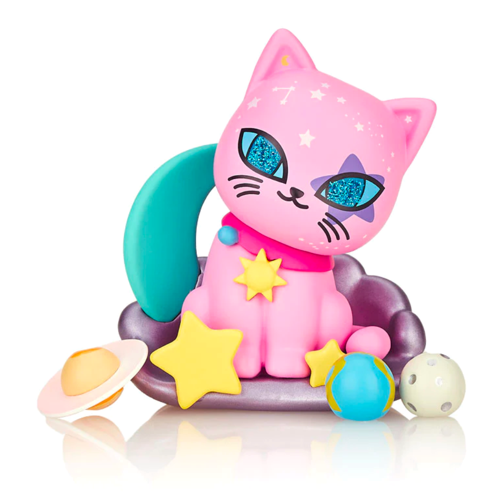 A pink cat from the tokidoki Galactic Cats - Blind Box is perched atop a star and other objects.