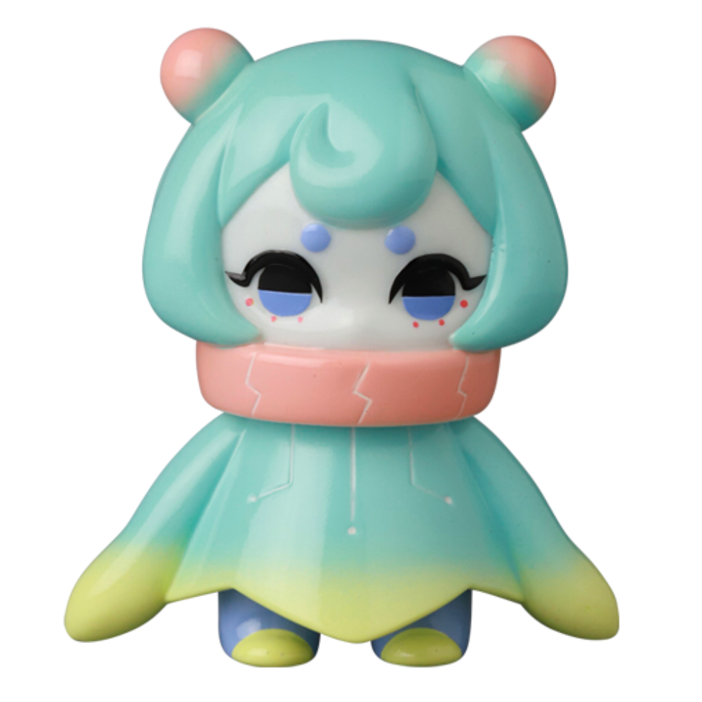 The VAG 10th Anniversary — Denshikodako by Medicom (JP) is a pastel-colored vinyl figure with a round head, big eyes, and a blue, green, and yellow cloak—perfect for Japanese vinyl toy collectors.