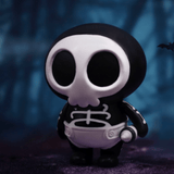 The Villain Baby - Blind Box by Partner Toys features a small figure with a black body, large white skull face, and skeleton costume—set against a dark backdrop with a distant bat—perfect for expanding your collection.