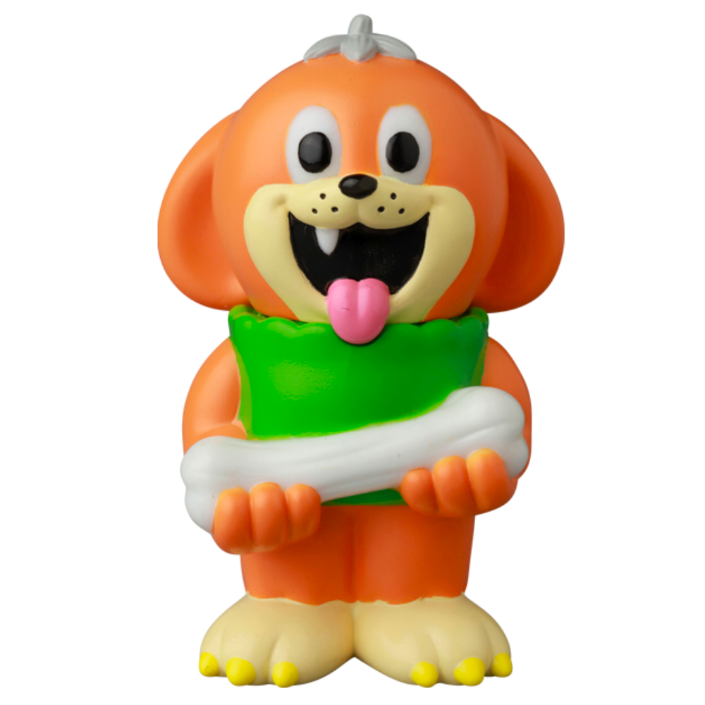 The VAG 43 — Uluru by Medicom (JP) is a cartoonish orange dog figurine with a big smile, holding a green pillow and a white bone, inspired by Japanese vinyl toy style, isolated on a white background.