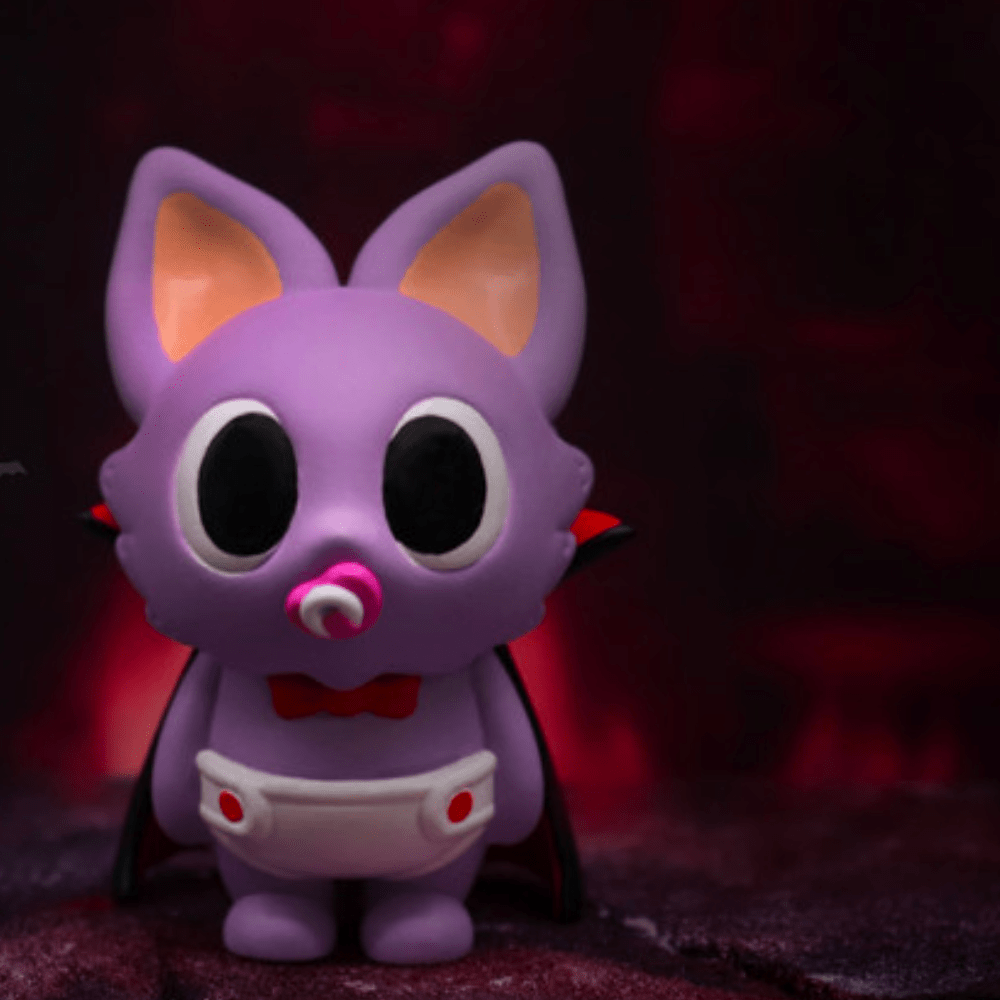 The Partner Toys Villain Baby - Blind Box features a purple cartoon bat figurine with big ears, a pacifier, red bow tie, and diaper against a dark red background—one of many adorable surprises you could unbox.
